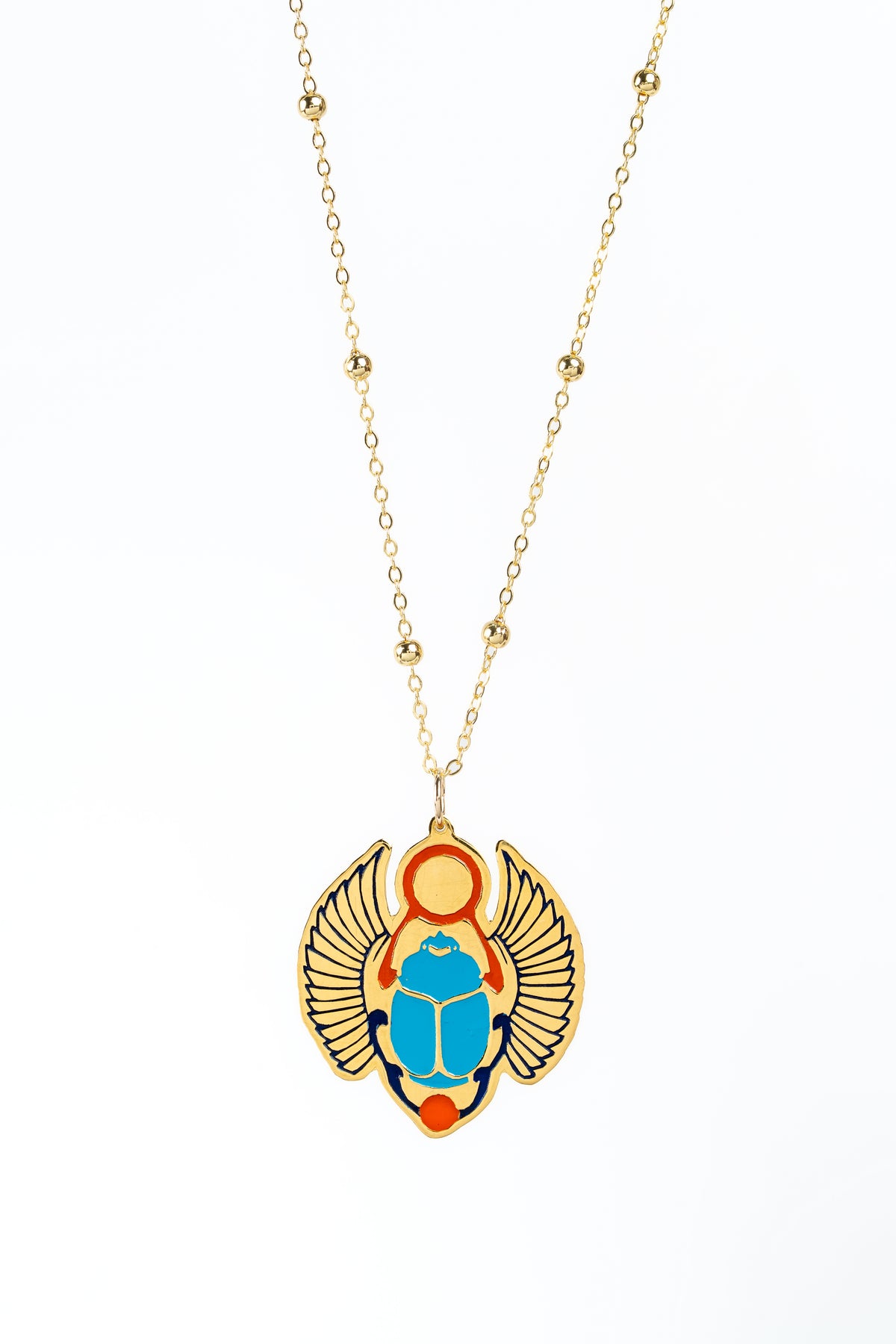A gold chain necklace featuring a winged scarab beetle pendant with a bright blue body, red accents, and navy details, set against a plain white background.